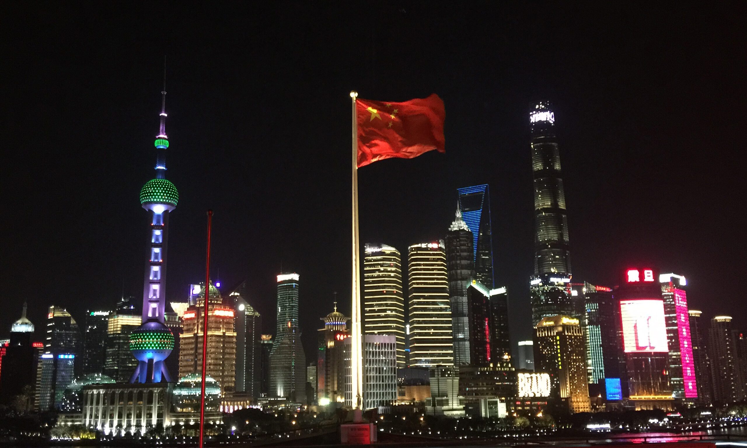 BOMA BEST - China's flag proudly flies over a city at night.