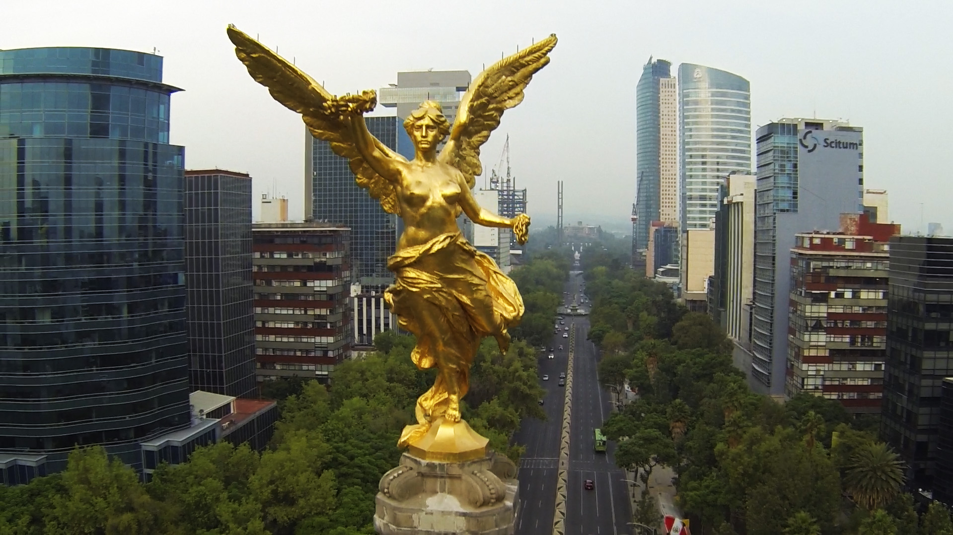 BOMA BEST - A golden statue of an angel expands its majestic presence in the middle of a city, captivating passersby with its exquisite beauty.