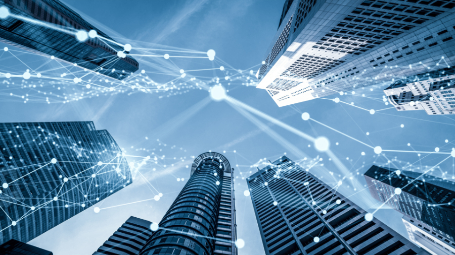 BOMA BEST - Digital network overlay on a cityscape with skyscrapers viewed from below under a clear sky, enhanced by smart sensors to drive sustainable initiatives.