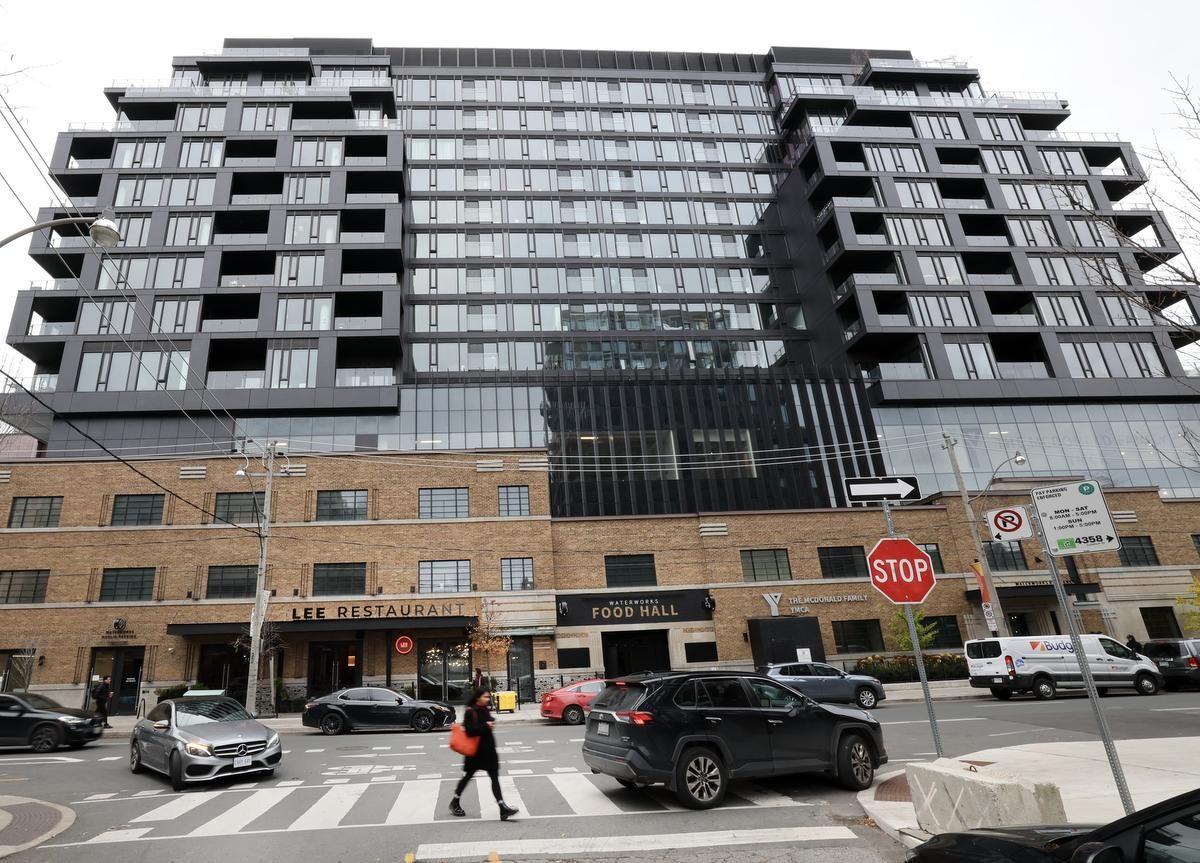 BOMA BEST - A multi-story modern building with balconies above a commercial ground floor featuring Lee Restaurant and Food Hall. Several cars and one pedestrian are at the intersection in front of the building, which boasts leased spaces dedicated to tenant sustainability initiatives.